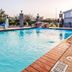 Baymont by Wyndham Laredo outdoor pool with brick deck, fenced seating area and rock water feature