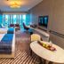 Vip Hotel in Doha guest room with two beds, desk, TV and balcony city view