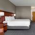 Courtyard by Marriott Boston Norwood/Canton guest room with king bed, desk, and TV in Norwood