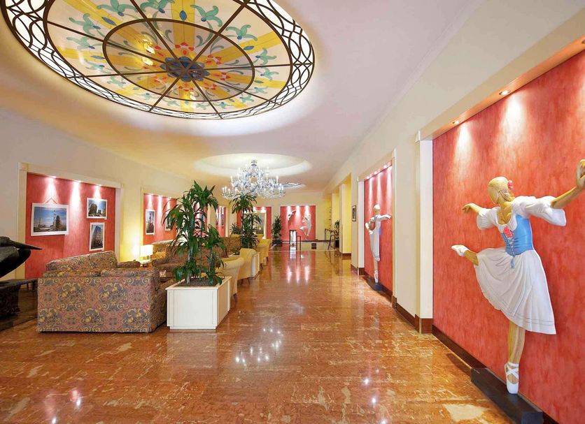 Mercure Reggio Emilia Centro Astoria lobby with stained-glass ceiling and polished marble floor