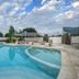 Aqua Resort in Diani Beach with a curved outdoor swimming pool and shaded seating area