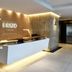 Brizo Salta lobby reception desk with warm wood paneling and elevator hall in Salta