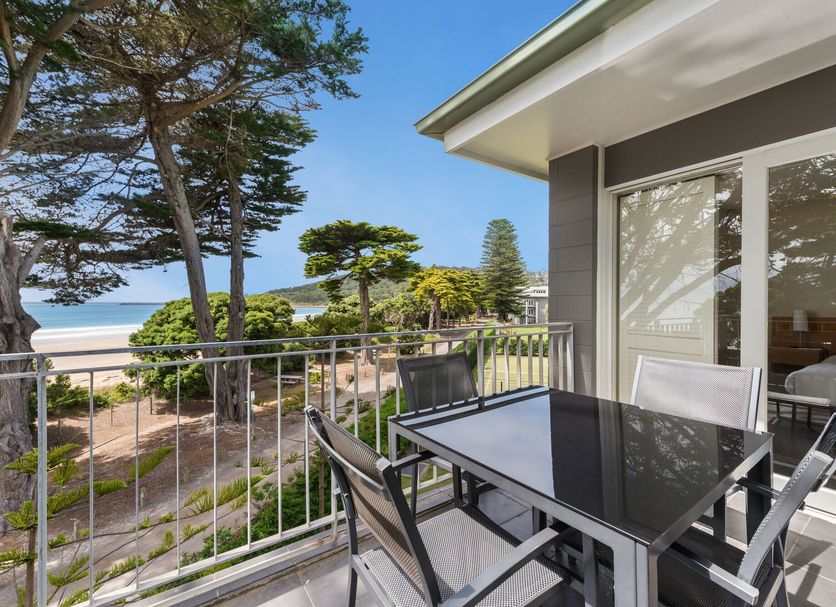 Mantra Lorne balcony with table and chairs overlooking gardens and the beach in Lorne