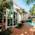 StayEasy Pretoria courtyard with palm trees, brick path and outdoor pool in Pretoria