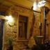 Cunda Mor Limon in Ayvalik, stone hotel exterior at night with warm lights and an open doorway