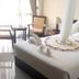 Asinuara Hotel Bahir Dar guest room with canopy bed, towel swans, and sitting area