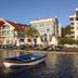 Orsmaris Boutique Hotel in Marmaris with beachfront loungers and a small boat on calm water