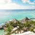 Be Live Experience Hamaca Suites in Boca Chica with palm trees, thatched palapas and turquoise ocean view