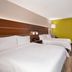 Holiday Inn Express Fairfax - Arlington Boulevard guest room with two beds, desk, and window