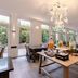 Garner Hotel Oberhausen By IHG dining area with chandelier, large windows, and long tables in Oberhausen
