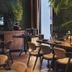 Spice House in Chiang Mai dining room with wooden tables, modern chairs, and lush tropical plants