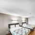 Motel 6 Moultrie, GA room with two beds and wood-look flooring in Moultrie