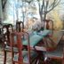 Hostal Bogotá Real dining room with wooden table, chairs and forest mural in Bogotá