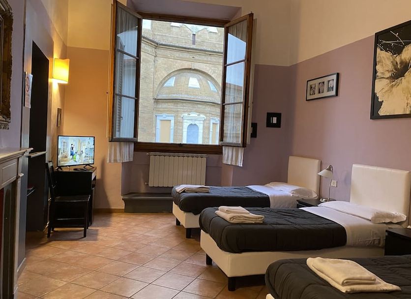 Emerald Palace Florence twin room with large open window and view of historic building