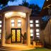 Zawadi House Arusha entrance at dusk with lit doorway, columns, and landscaped entryway