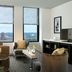 Renaissance Cincinnati Downtown Hotel suite with city skyline view through large windows