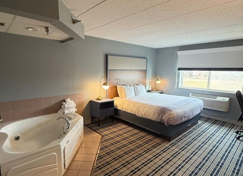 Americinn By Wyndham St. Cloud Mn I-94 guest room with whirlpool tub, king bed and window view