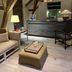 B&B The Verhaegen Ghent lounge with exposed beams, reception desk, armchair and ottoman