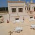 Agriturismo I Pozzetti in Fasano with a sunlit rooftop terrace, outdoor seating, and sea views