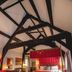 The Old Vicarage Hotel & Restaurant, Bridgwater: four-poster bed in a beamed guest room with red decor