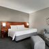 Courtyard by Marriott Fort Myers Cape Coral guest room with king bed and sofa seating in Fort Myers