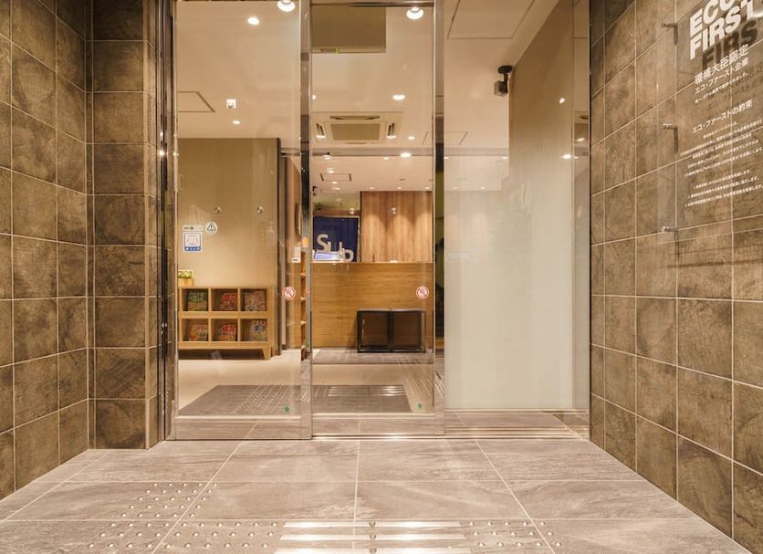 Super Hotel Tokyo Jr Kamata Nishiguchi lobby entrance with glass doors and tiled walls in Tokyo