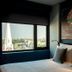 Hotel G Yangon room with city view through large window and art mural above the bed