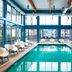Aloft Seattle Redmond indoor pool with lounge chairs and large windows in Redmond