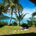 Barefoot Kuata Island, Kuata Island: tropical beachfront lawn with palm trees and turquoise ocean view
