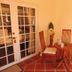 Karibu Aruba in Noord patio with two wooden chairs and a small round table by glass doors