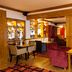 Premier Inn Rugeley lounge with seating, tables, warm lighting and display shelving