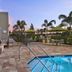 TownePlace Suites by Marriott Naples poolside patio with fire pit, lounge seating and palm trees at dusk