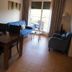 Águilas de los Collados in Águilas: living room with sofa, dining table and balcony doors