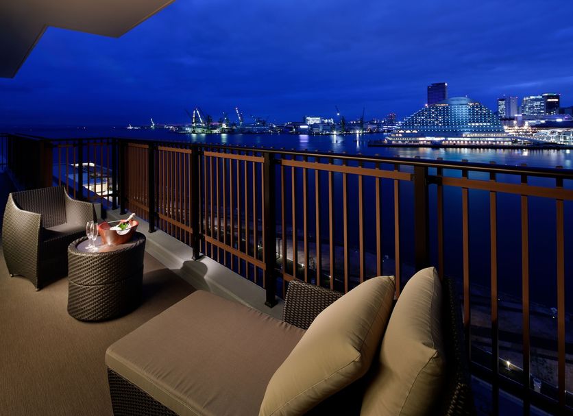 Kobe Minato Onsen Ren balcony with lounge chairs and harbor skyline view in Kobe