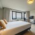 Leonardo Hotel Ijmuiden Seaport Beach room with king bed, desk, TV and large window view in IJmuiden