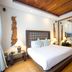 7Stones Boracay bedroom with wood ceiling, platform bed and mirrored wardrobe in Boracay