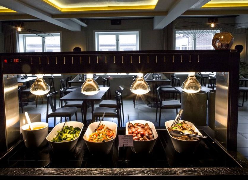 Fredriksten Hotell in Halden breakfast buffet with salads, fruit and hot dishes under warming lights