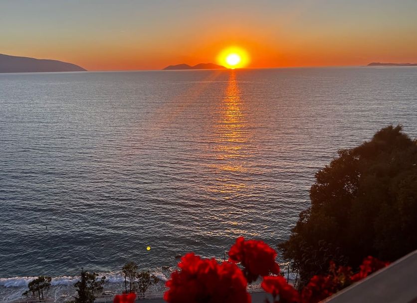 Le Palazzine Hotel in Vlorë with a sunset over the sea and distant islands from the hotel terrace