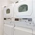 Travelodge by Wyndham Sacramento/Rancho Cordova laundry room with stacked washer and dryer units