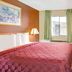Travelodge by Wyndham Sacramento / Rancho Cordova guest room with bed, desk, TV, and window
