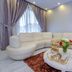 Arabella Residence Cairo lounge with curved cream sofa, round coffee table, flowers, and gold decor