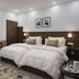 Hotel Harmony in Khajurāho guest room with twin beds, desk, wardrobe, and bedside lamps