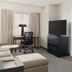 Residence Inn by Marriott Dayton Vandalia suite with desk, TV, seating area and bedroom doorway in Dayton