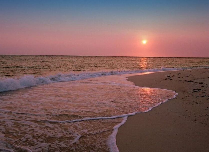 Eden Beach Saint-Louis beach at sunset with waves rolling onto the shore in Saint-Louis