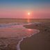 Eden Beach Saint-Louis beach at sunset with waves rolling onto the shore in Saint-Louis