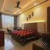 Hotel Chevron International in Ludhiāna room with large window, bed, desk and ceiling fan