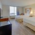 Capital O Duncanville Tx guest room with two beds, window view and light wood flooring in Duncanville