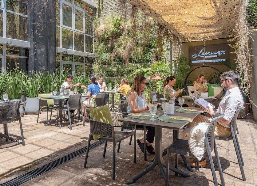 Outdoor patio dining at Lennox Hotel Buenos Aires in Buenos Aires with guests at tables