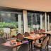 Waldhotel Porta Westfalica dining room with large windows and garden views in Porta Westfalica