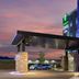 Holiday Inn Express & Suites Colorado Springs South I-25 By IHG exterior with blue-lit facade at sunset